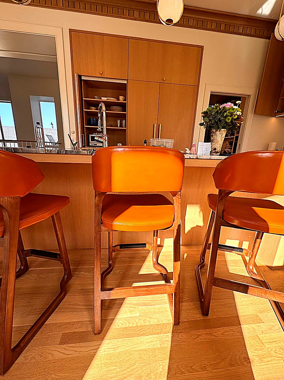 Perry D. Smith &mdash; Orange leather counter stools at kitchen island